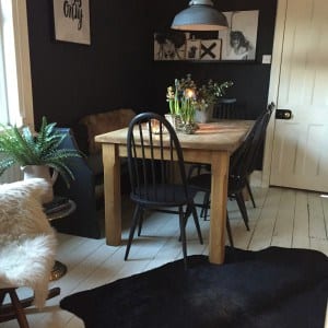 oak table, dark blue painted chairs and industrial lighting