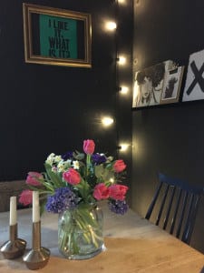 dining room with faux pink and purple flowers and fairy lights